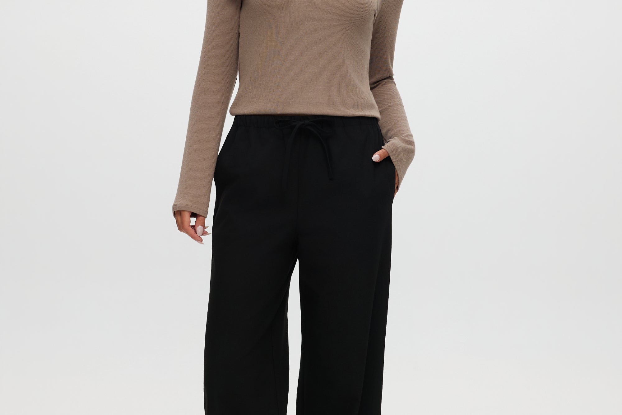 Black straight leg pull-on pants with elastic waistband and drawcord, featuring side pockets.