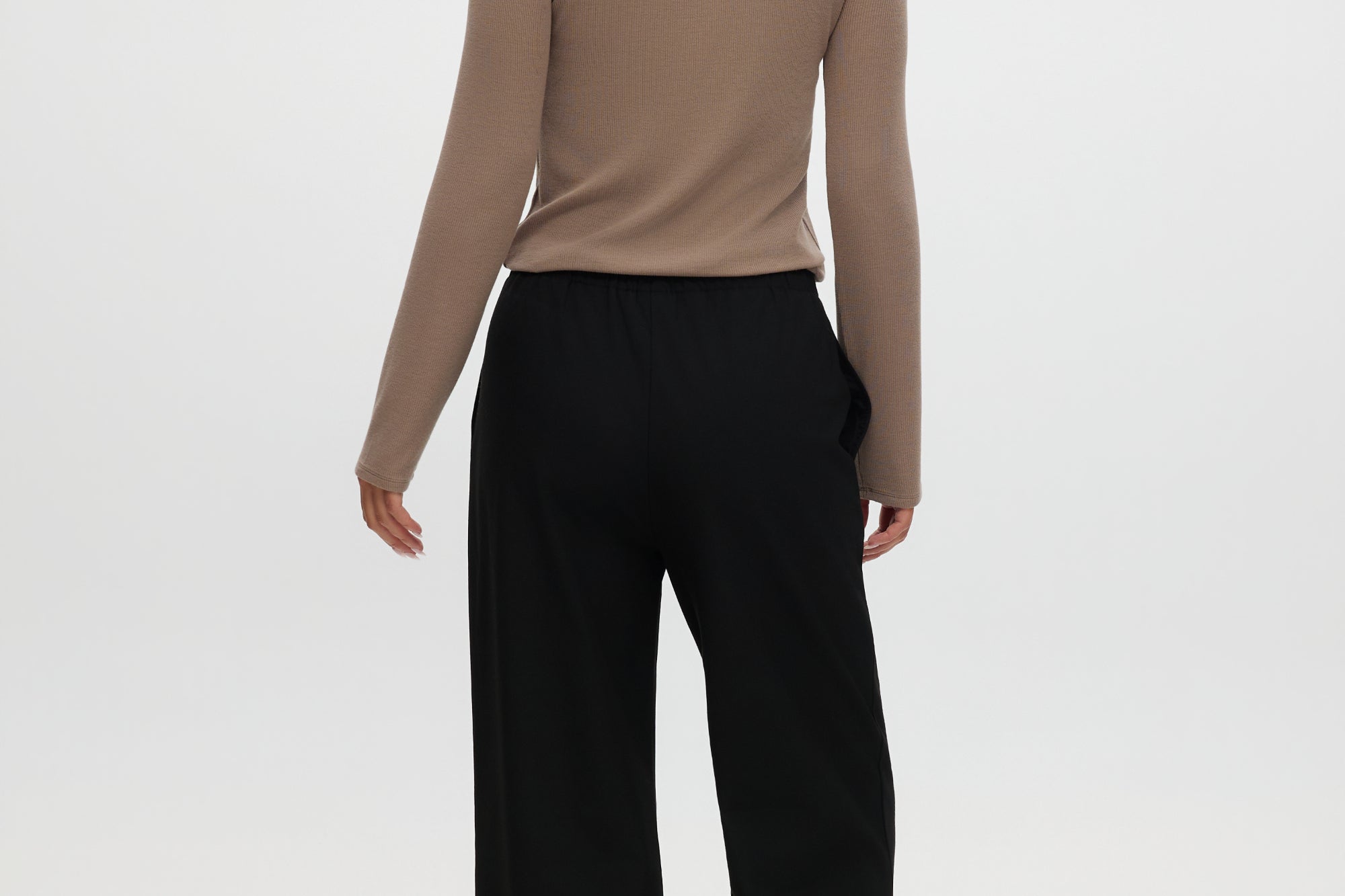 Black straight leg pull-on pants with elastic waistband, drawcord, and side pockets by Hilary Radley.