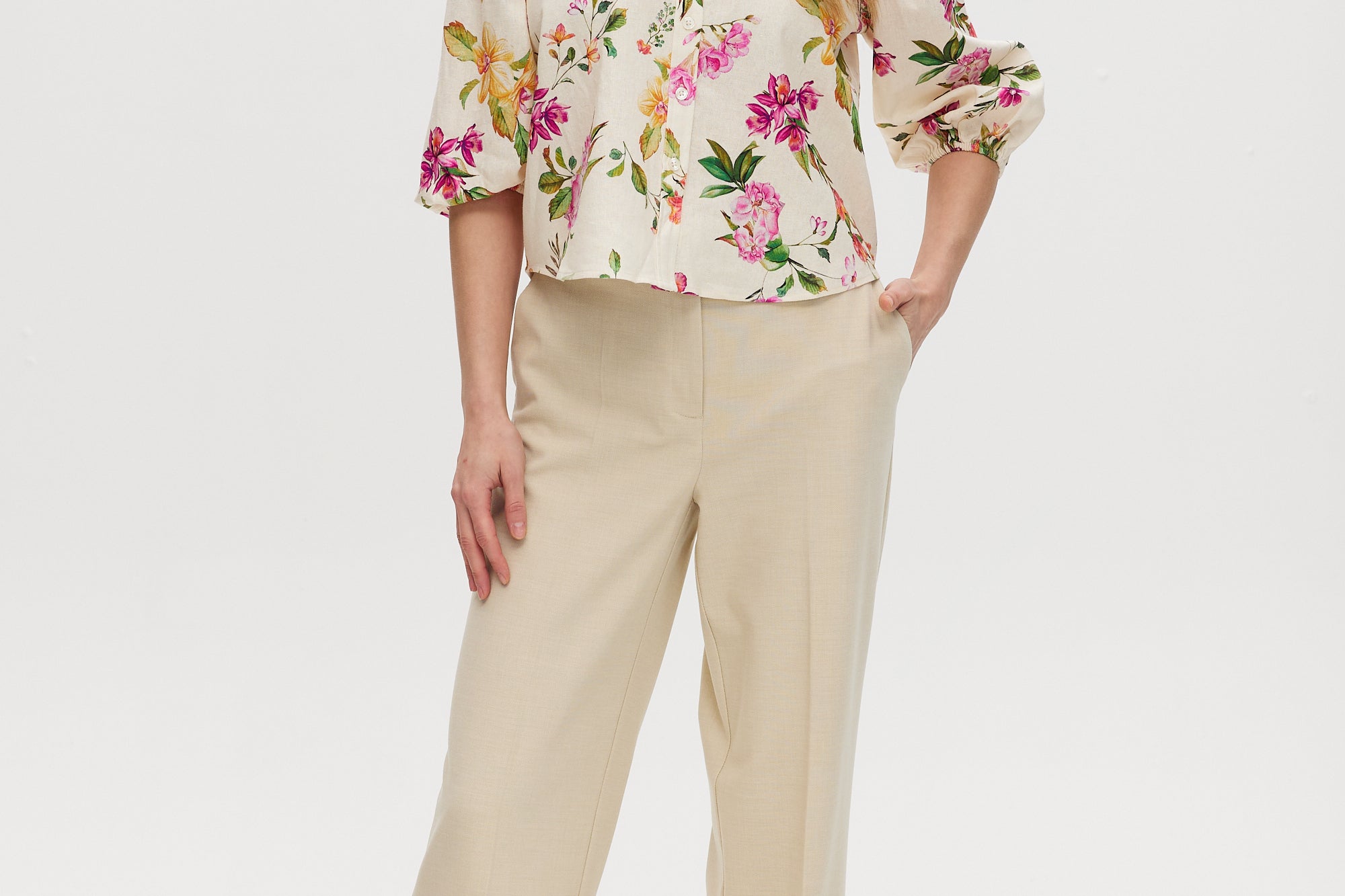 Cream floral linen blend blouse featuring puff sleeves and button-front closure by Hilary Radley.