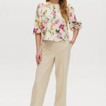Cream floral linen blend blouse featuring puff sleeves and button-front closure by Hilary Radley.