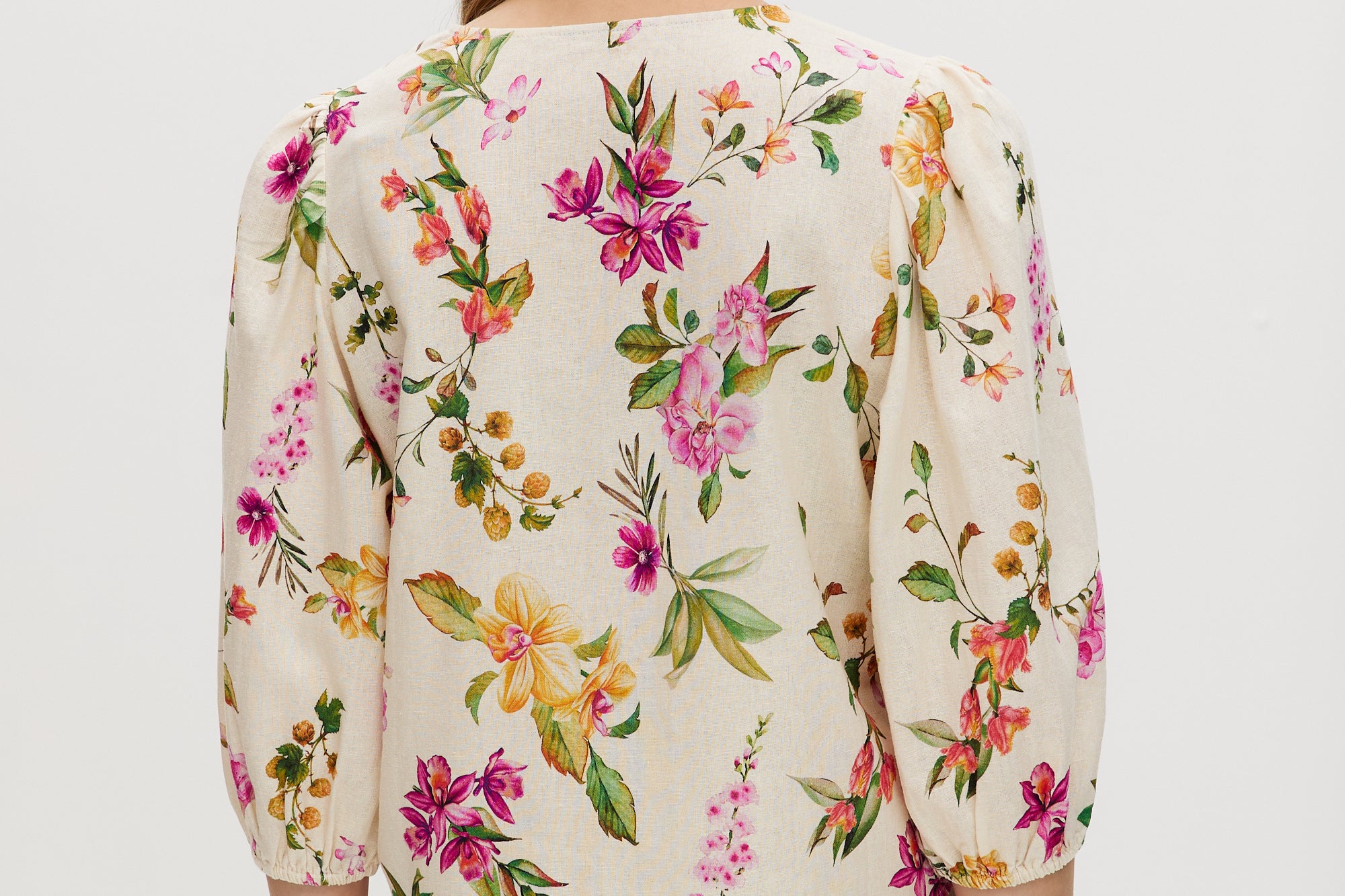 Cream floral linen blend blouse featuring puff sleeves and button-front closure by Hilary Radley.