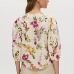 Cream floral linen blend blouse featuring puff sleeves and button-front closure by Hilary Radley.