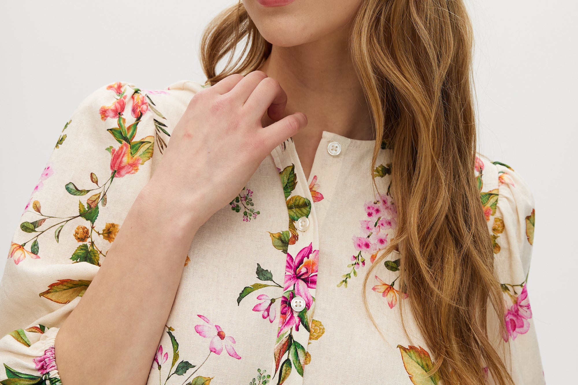 Cream floral linen blend blouse featuring puff sleeves and button-front closure by Hilary Radley.