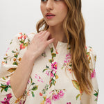 Cream floral linen blend blouse featuring puff sleeves and button-front closure by Hilary Radley.