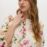 Cream floral linen blend blouse featuring puff sleeves and button-front closure by Hilary Radley.