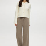 Cream knit cardigan with round collar and patch pockets by Hilary Radley.