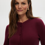 Burgundy knit cardigan featuring a round collar and patch pockets by Hilary Radley.