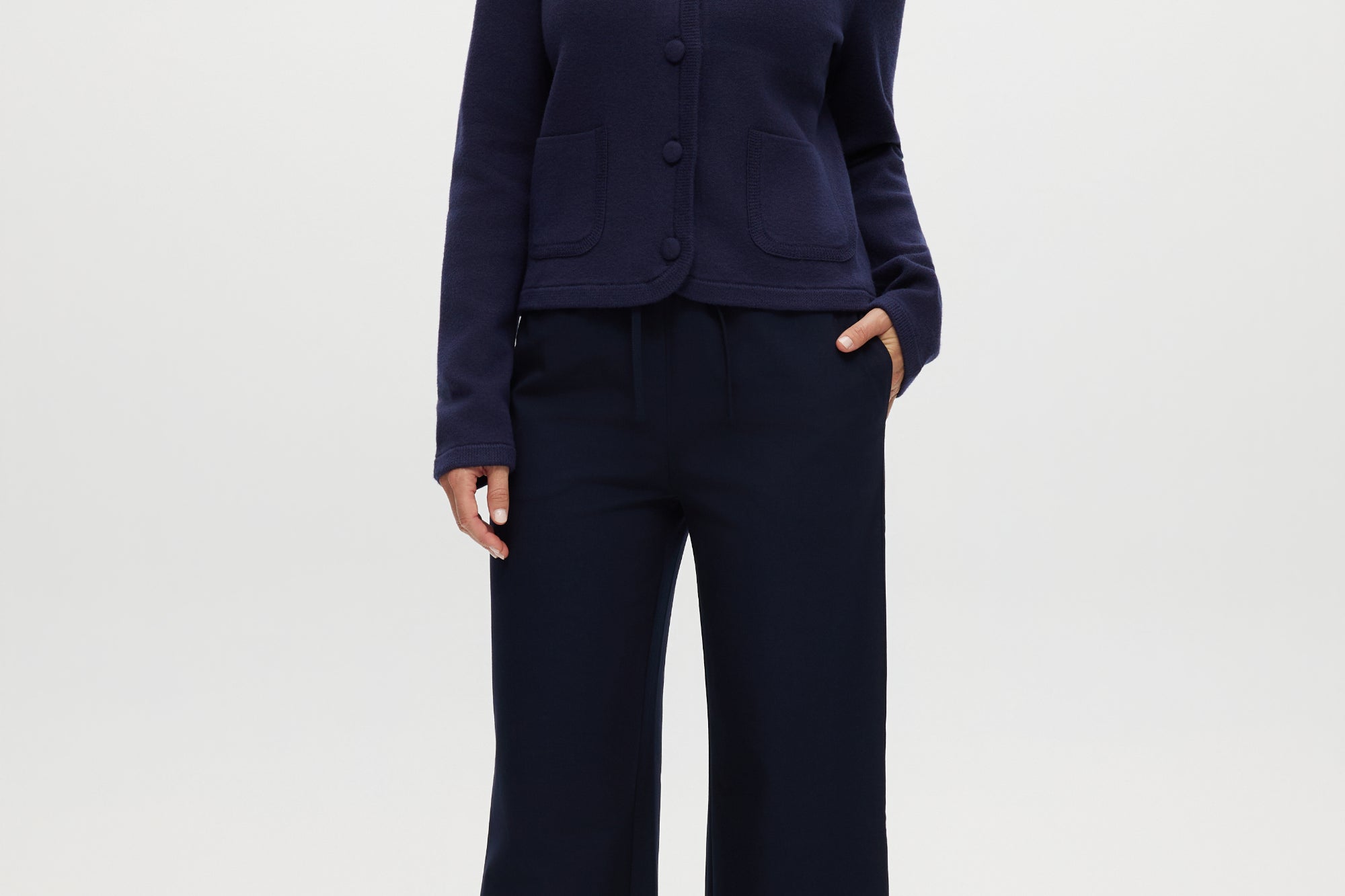 Navy Round Collar Knit Cardigan featuring long sleeves and front pockets by Hilary Radley.