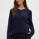 Navy knit cardigan with round collar, long sleeves, and front pockets.