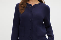 Navy knit cardigan with round collar, long sleeves, and front pockets.