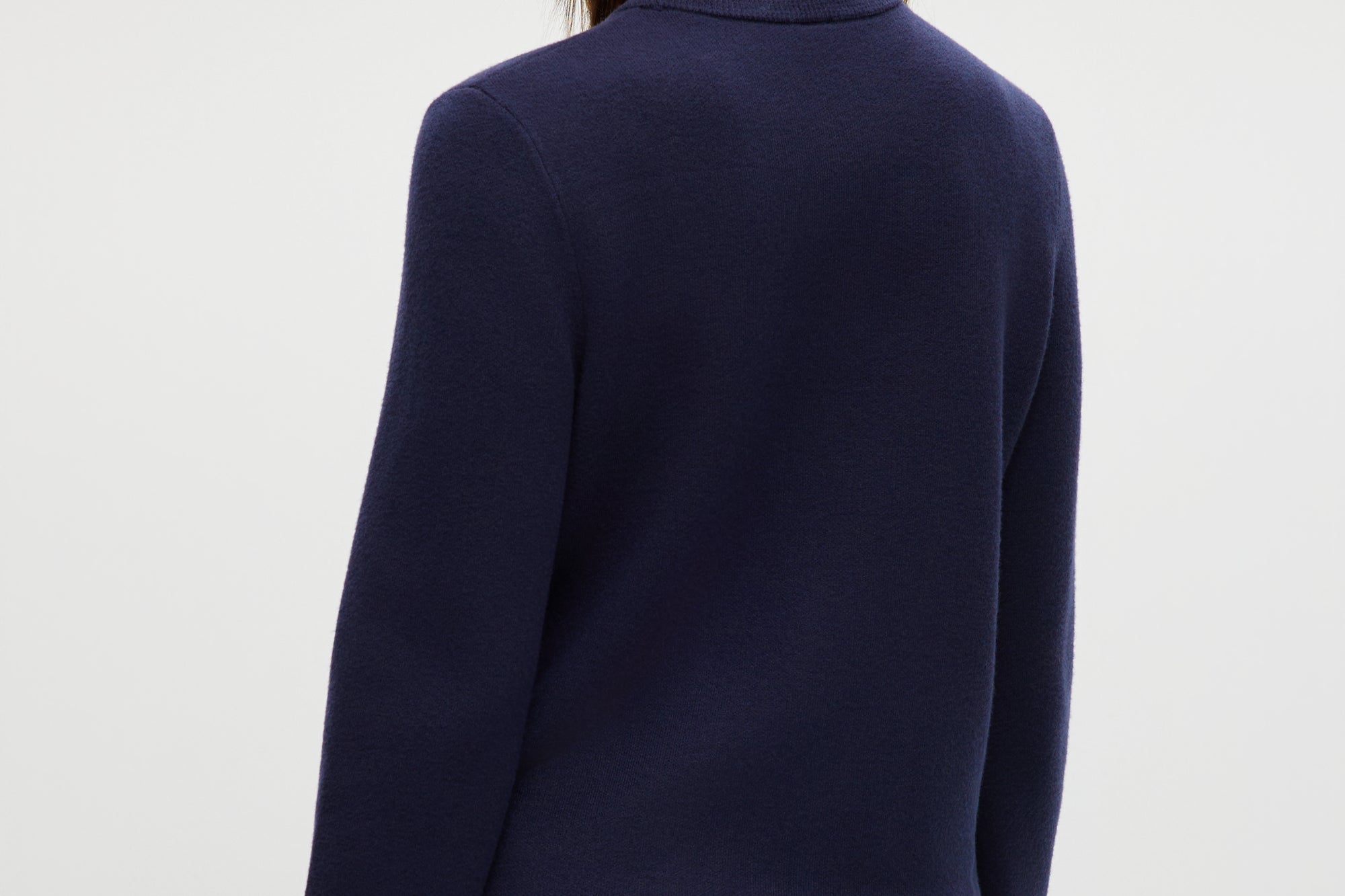 Navy knit cardigan featuring a round collar, long sleeves, and front pockets by Hilary Radley.
