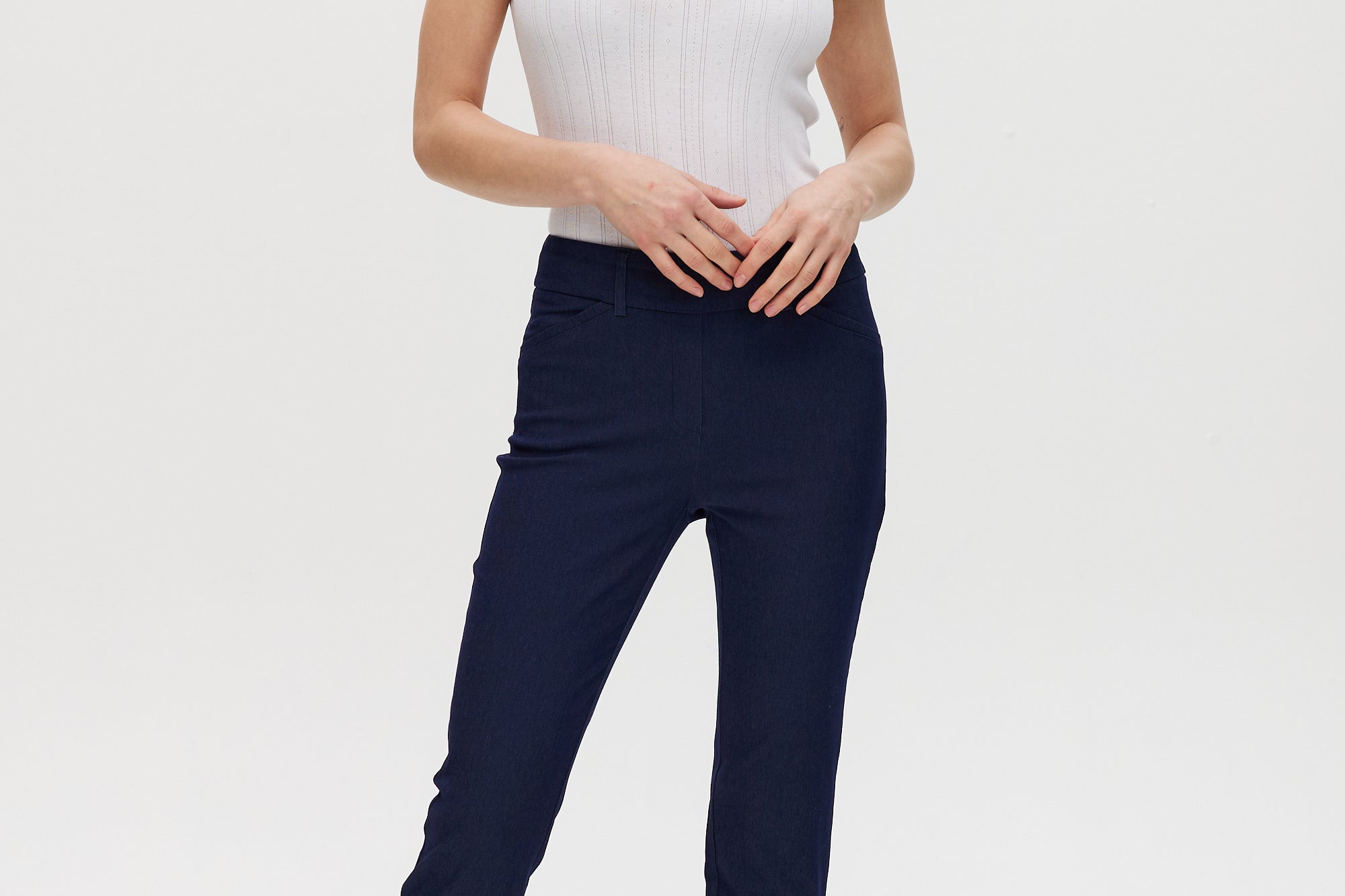 Navy capri pants, super stretch pull-on with functional front pockets and faux back pockets.