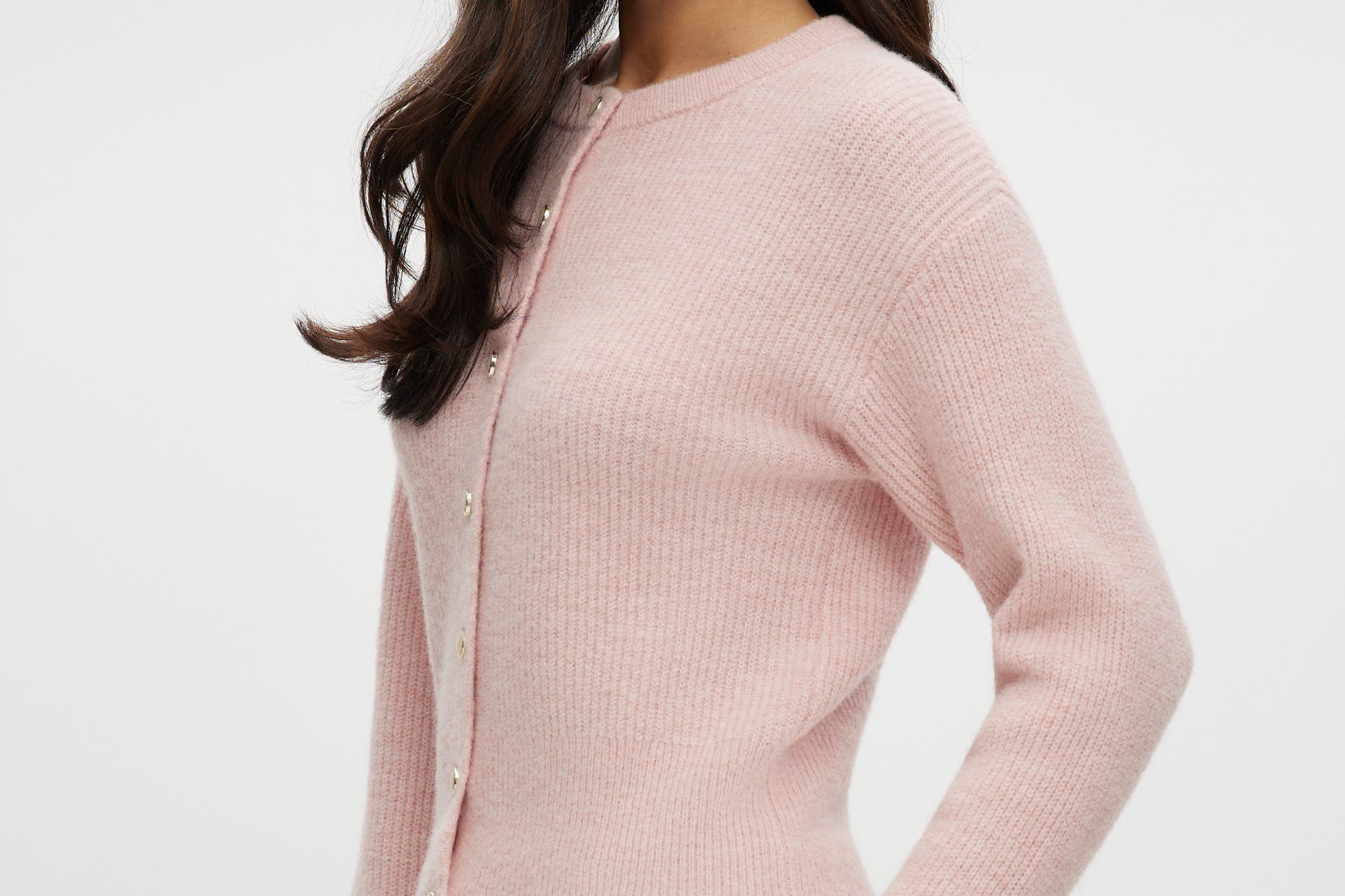 Pink shaker stitch crew neck cardigan with button-front closure by Hilary Radley.