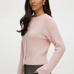 Pink shaker stitch crew neck cardigan with button-front closure by Hilary Radley.