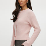 Pink shaker stitch crew neck cardigan with button-front closure by Hilary Radley.