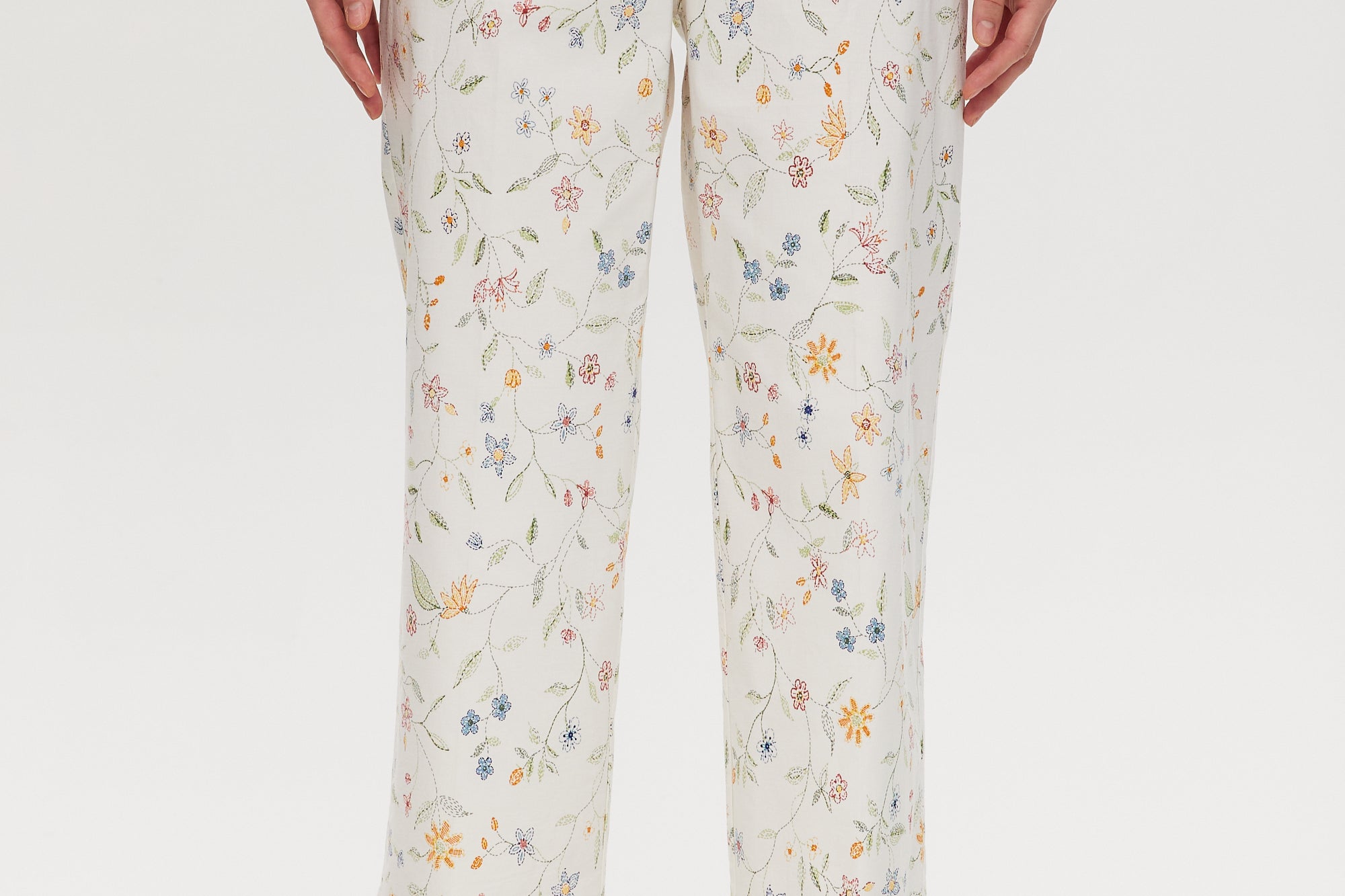 White High-Rise Floral Straight Leg Pant with button-front closure and pockets, sold by Hilary Radley.