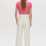 White high-rise straight leg pants with a floral print, button-front closure, and pockets by Hilary Radley.