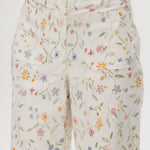 White high-rise straight leg pants with floral print, featuring a button-front closure and pockets by Hilary Radley.