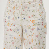White high-rise straight leg pants with floral print, featuring a button-front closure and pockets by Hilary Radley.