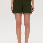 Olive high-rise stretch shorts featuring button closure, front patch pockets, and textured fabric by Hilary Radley.