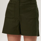 Olive high-rise stretch shorts featuring a button closure, front patch pockets, and textured fabric by Hilary Radley.
