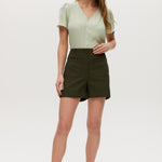 Olive high-rise shorts with button closure, front patch pockets, and textured fabric.