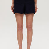 Navy high-rise stretch shorts featuring a structured waistband and functional pockets by Hilary Radley.