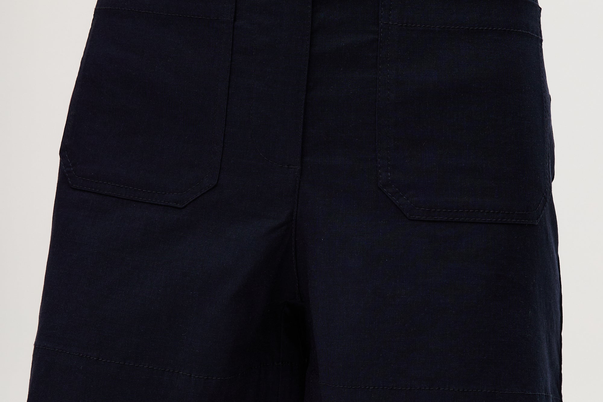 Navy high-rise stretch shorts featuring a structured waistband and functional pockets by Hilary Radley.