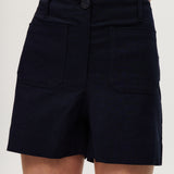 Navy high-rise stretch shorts featuring a structured waistband and functional pockets by Hilary Radley.
