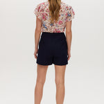 Navy high-rise stretch shorts featuring a structured waistband and functional pockets by Hilary Radley.