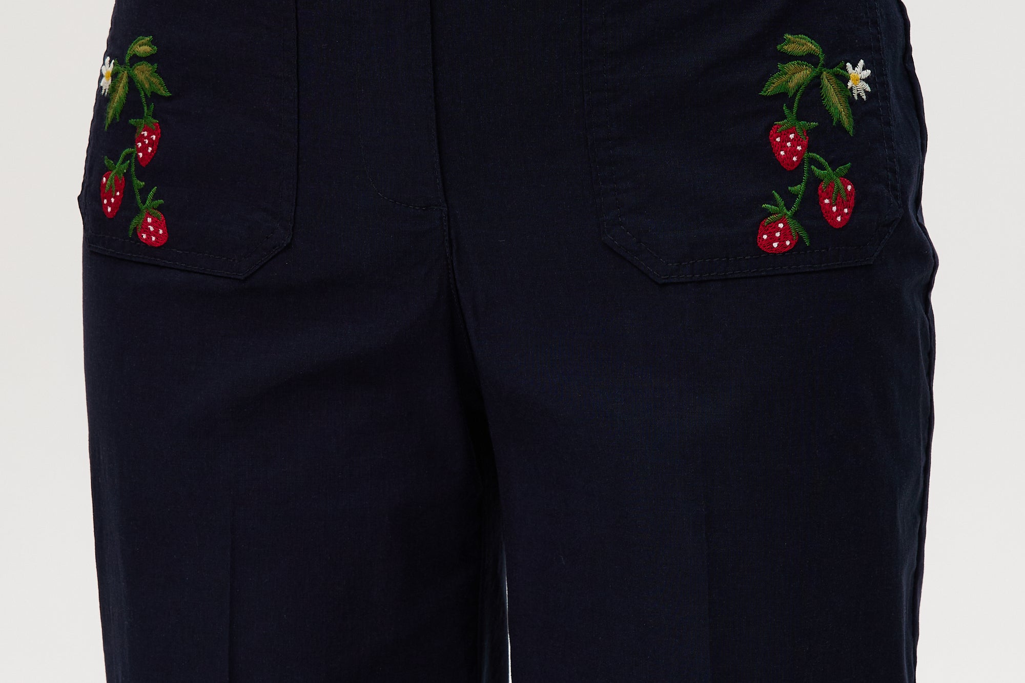 Navy high-rise straight leg pants featuring charming embroidery and front patch pockets by Hilary Radley.