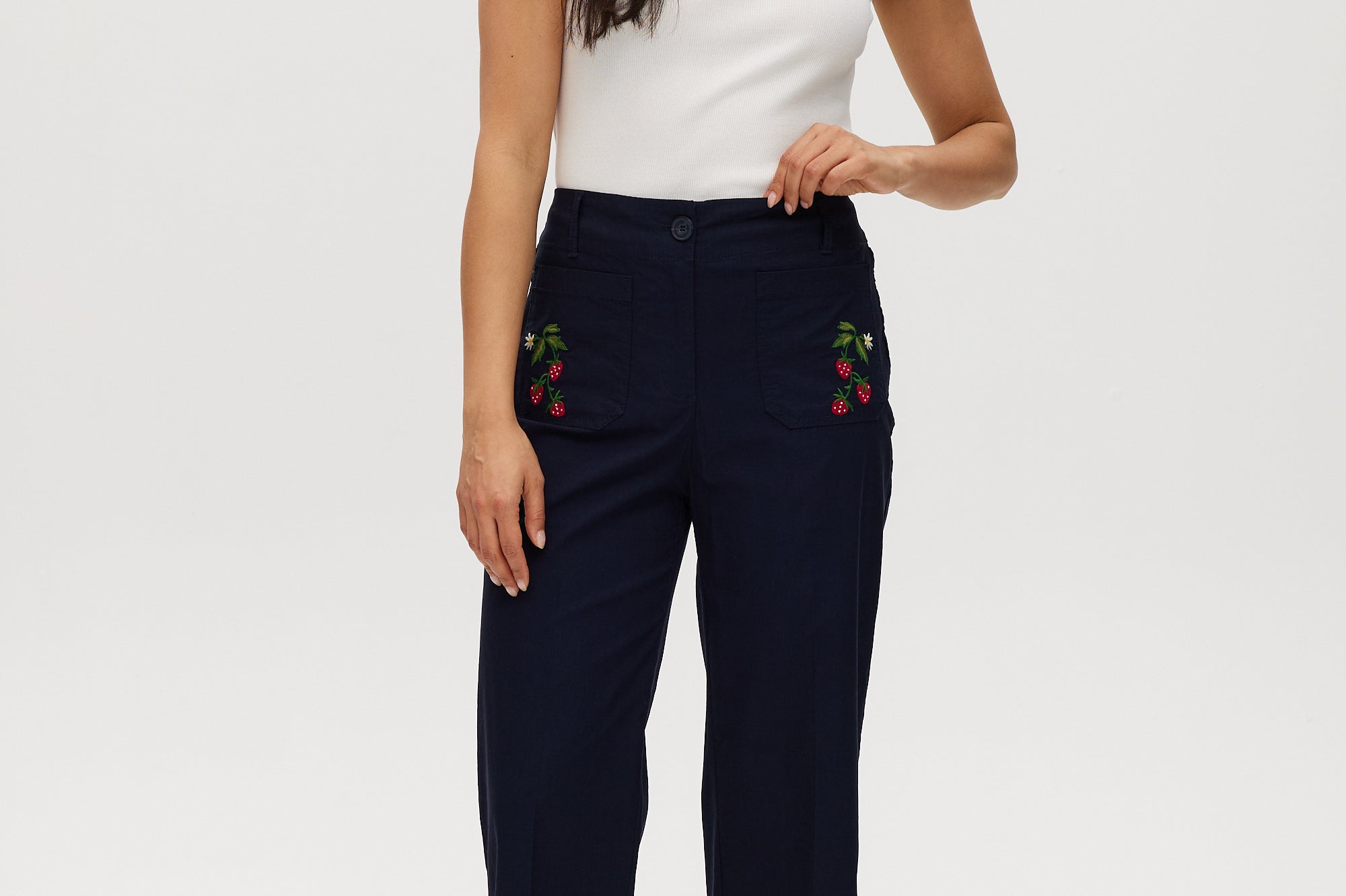 Navy high-rise straight leg pants with embroidery and front patch pockets.