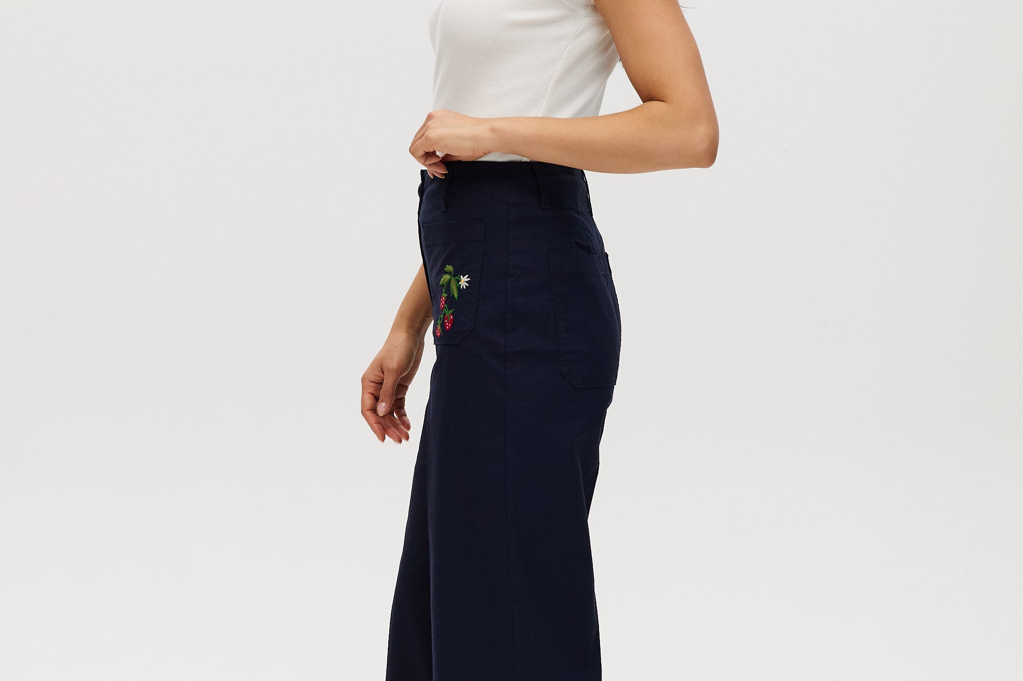 Navy high-rise straight leg pants featuring embroidery and front patch pockets by Hilary Radley.