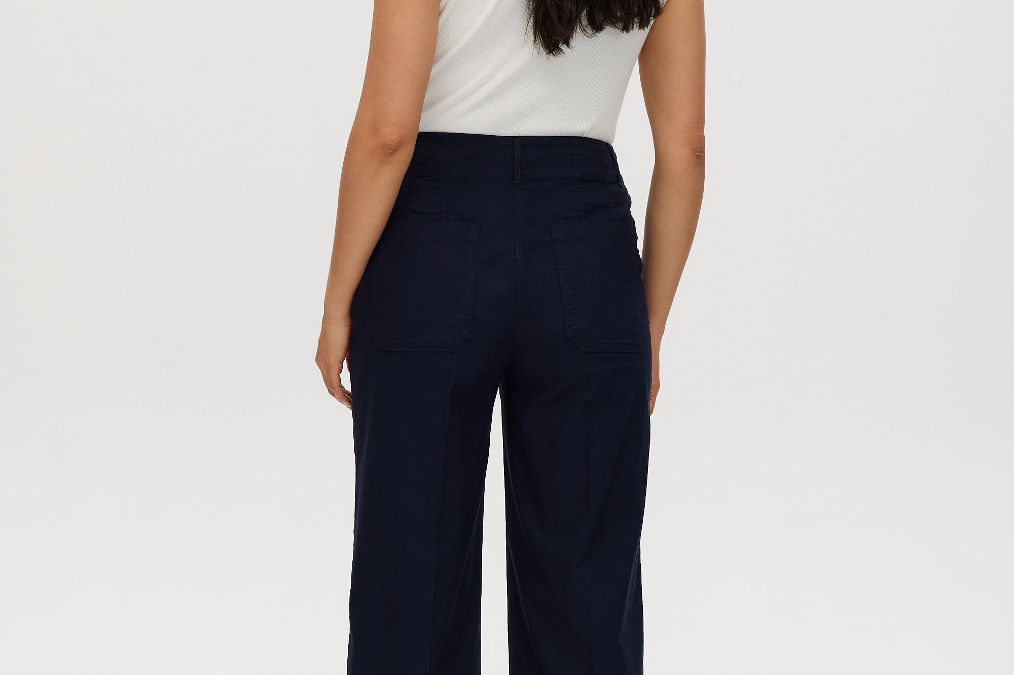 Navy high-rise straight leg pants featuring embroidery and front patch pockets by Hilary Radley.