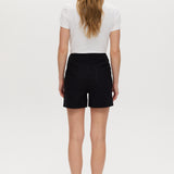 Black high-rise stretch shorts featuring button closure and front patch pockets by Hilary Radley.
