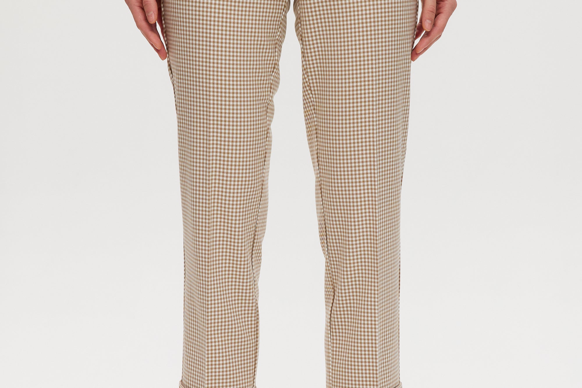 Beige checked slim leg pants featuring a button-front and pockets, available from Hilary Radley.