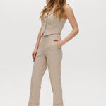 Beige checked slim leg pants and vest set featuring a button-front design with pockets by Hilary Radley.