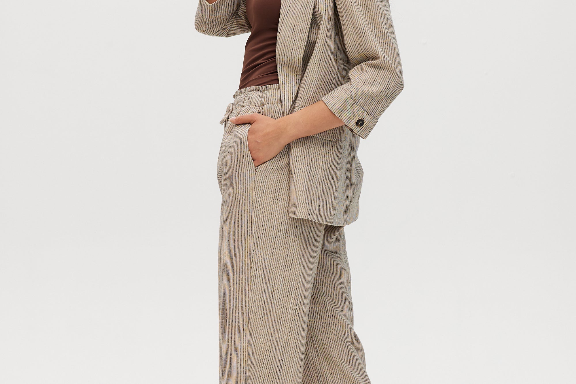 Beige yarn-dye linen stripe pull-on pants with elastic waistband, paired with a matching blazer by Hilary Radley.
