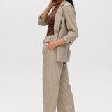 Beige yarn-dye linen stripe pull-on pants with elastic waistband, paired with a matching blazer by Hilary Radley.