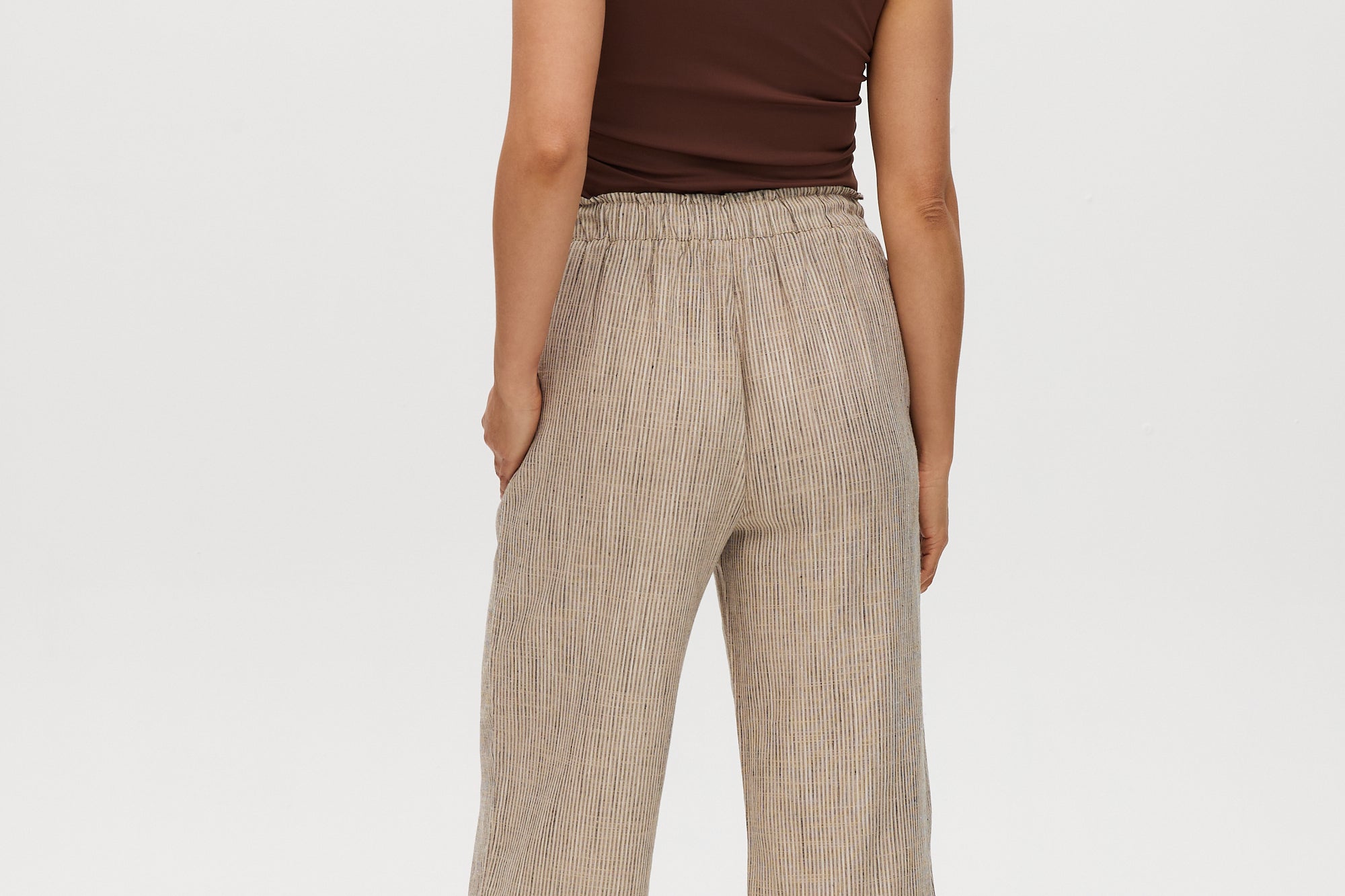 Beige yarn-dye linen stripe pull-on pants featuring an elastic waistband, available from Hilary Radley.