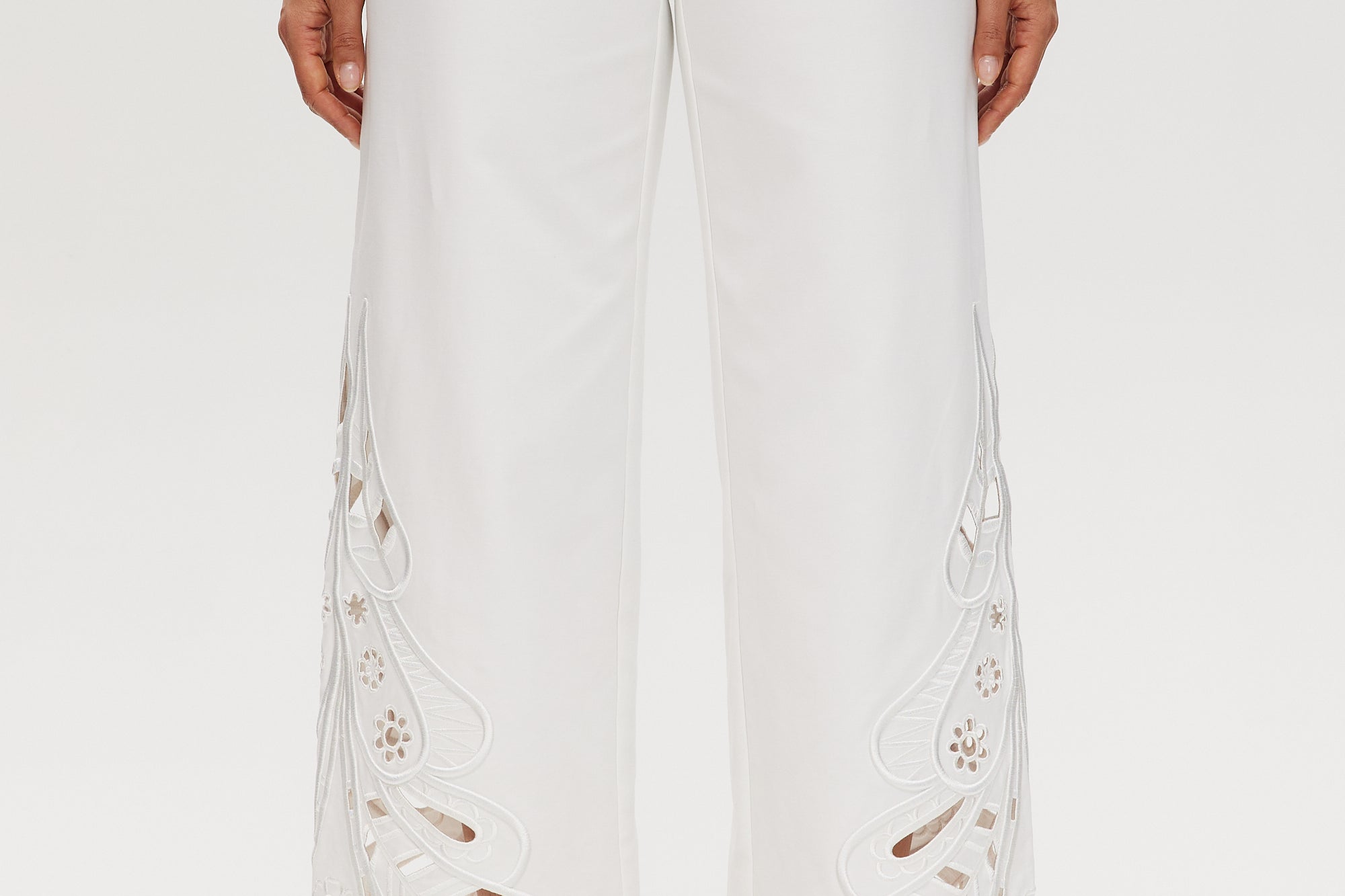 Off-White embroidered cotton straight leg pants featuring a pull-on waistband and intricate hem embroidery by Hilary Radley.
