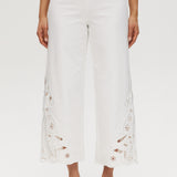 Off-White embroidered cotton straight leg pants featuring a pull-on waistband and intricate hem embroidery by Hilary Radley.
