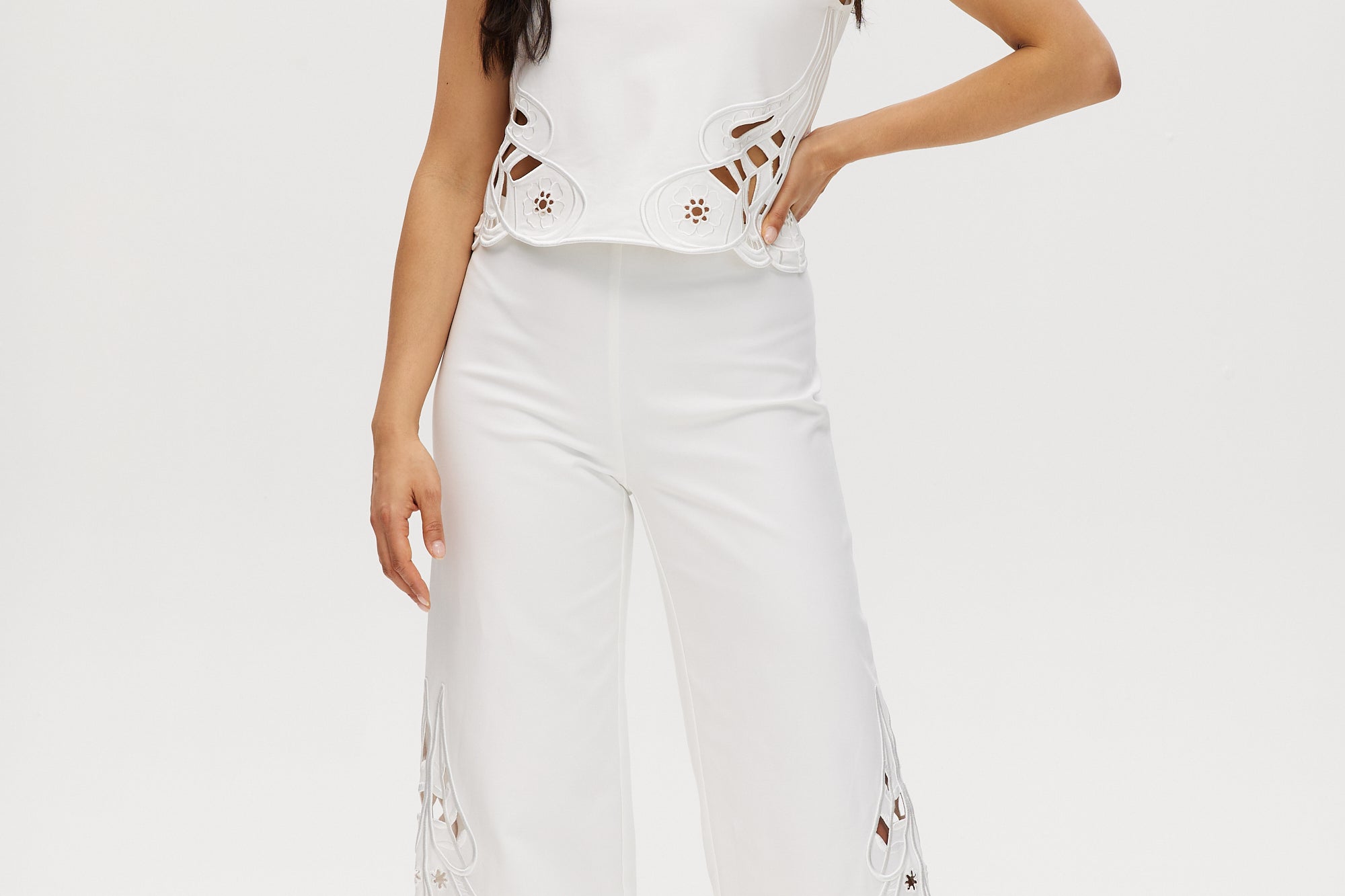 Off-White embroidered cotton straight leg pants with pull-on waistband and hem embroidery.