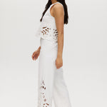 Off-White embroidered cotton straight leg pants featuring a pull-on waistband and intricate hem embroidery by Hilary Radley.