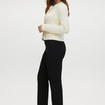 Black skinny leg pull-on pant featuring an elastic waistband and side pockets by Hilary Radley.