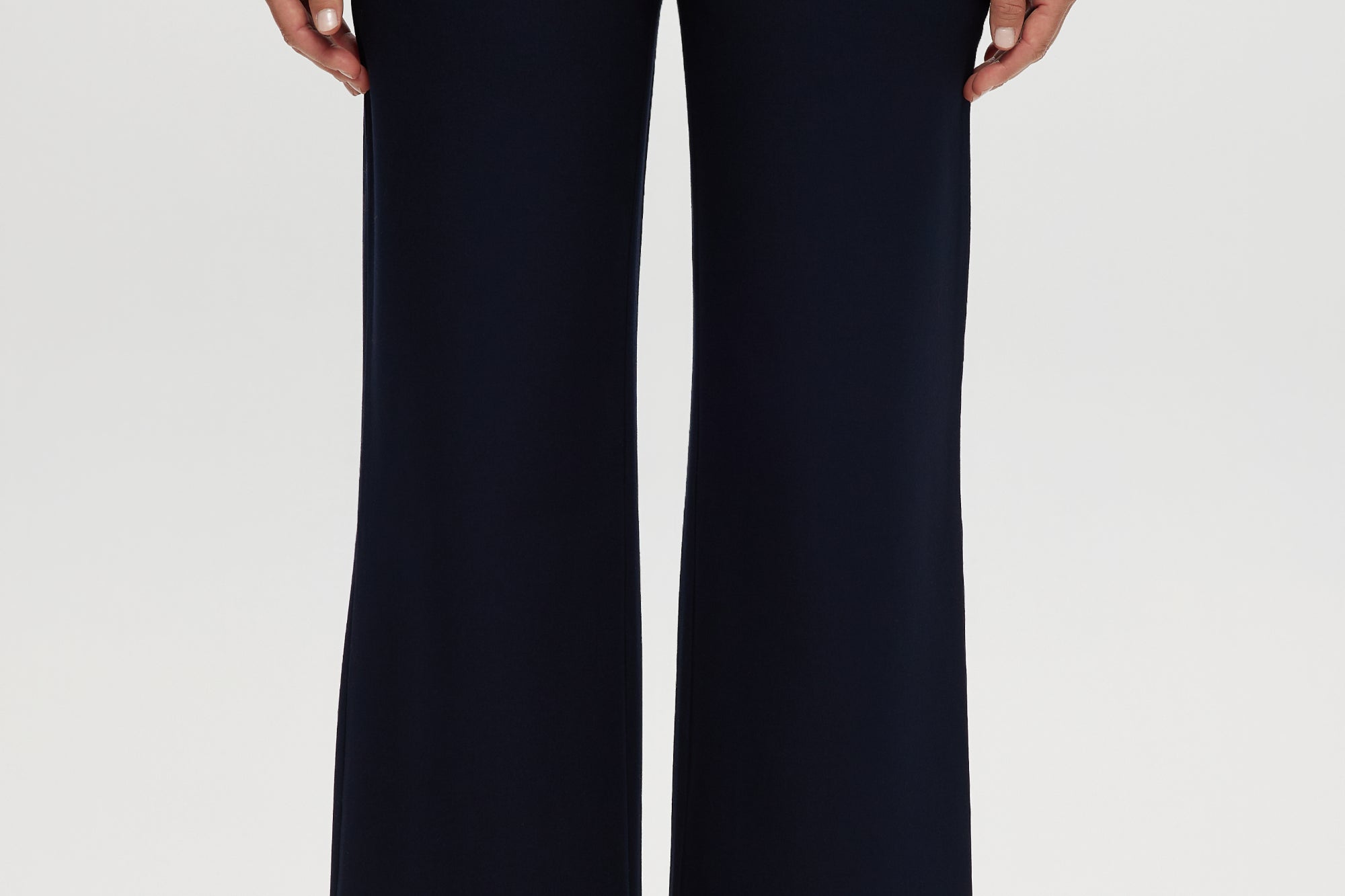 Navy pull-on straight leg pants featuring an elastic waistband and side pockets by Hilary Radley.