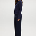 Navy pull-on straight leg pants featuring an elastic waistband and side pockets by Hilary Radley.