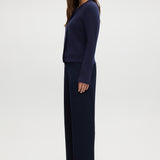 Navy pull-on straight leg pants featuring an elastic waistband and side pockets by Hilary Radley.