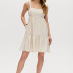 Beige midi dress with tiered skirt, adjustable straps, and smocked back.