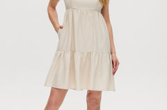 Beige midi dress with tiered skirt, adjustable straps, and smocked back.